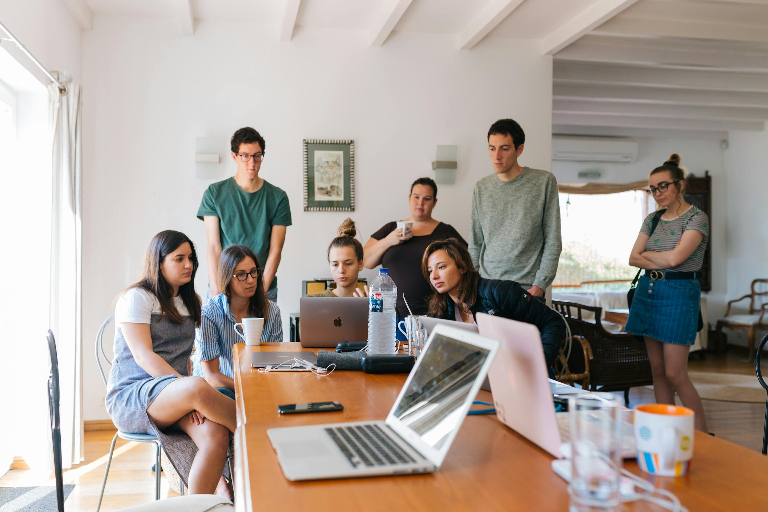 Group of young professionals engaged in a training session in a modern office setting.