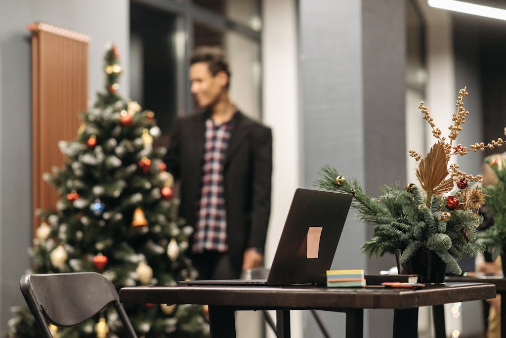 Modern office space decorated for Christmas with tree and festive ornaments.