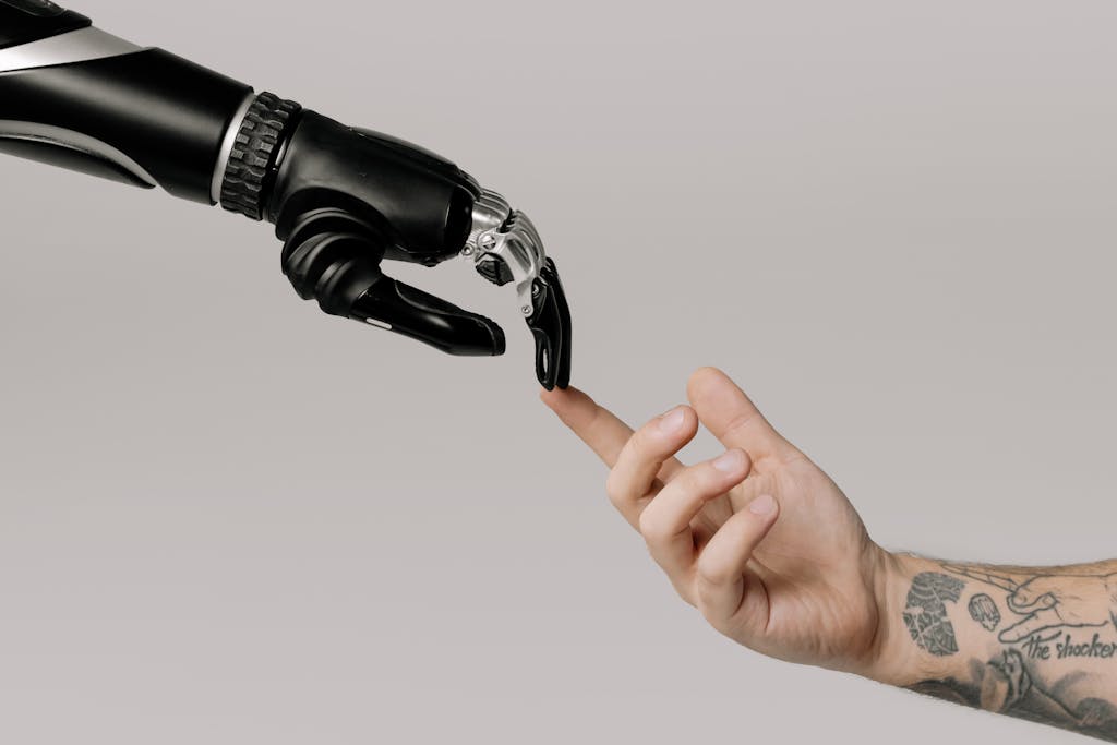 A human hand with tattoos reaching out to a robotic hand on a white background. Référence à l'IA Act
